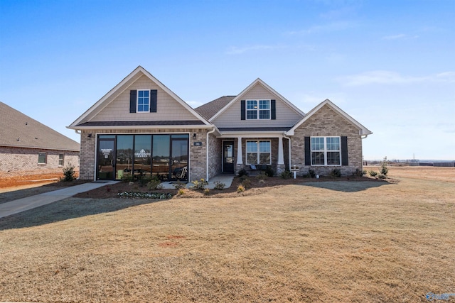 craftsman-style house with a front yard