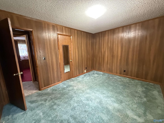 4435 Pilgrims Rest Rd, Southside, AL 35907 - carpeted spare room with a textured ceiling and wooden walls