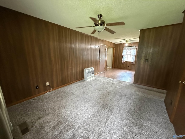 4435 Pilgrims Rest Rd, Southside, AL 35907 - carpeted spare room featuring heating unit, a textured ceiling, a ceiling fan, and wood walls