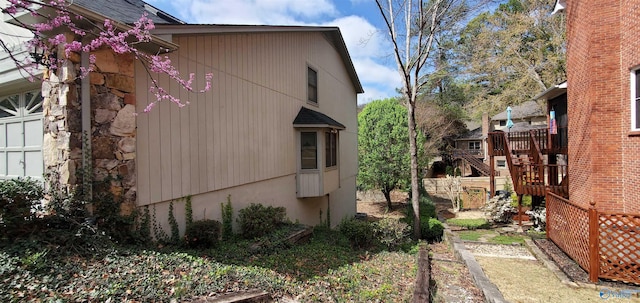 view of side of home with a wooden deck