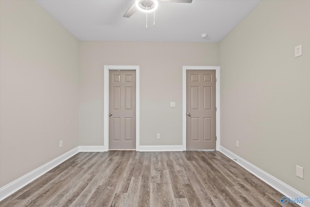 unfurnished room with ceiling fan and light hardwood / wood-style flooring