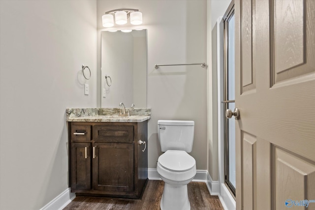 bathroom featuring vanity, hardwood / wood-style floors, and toilet