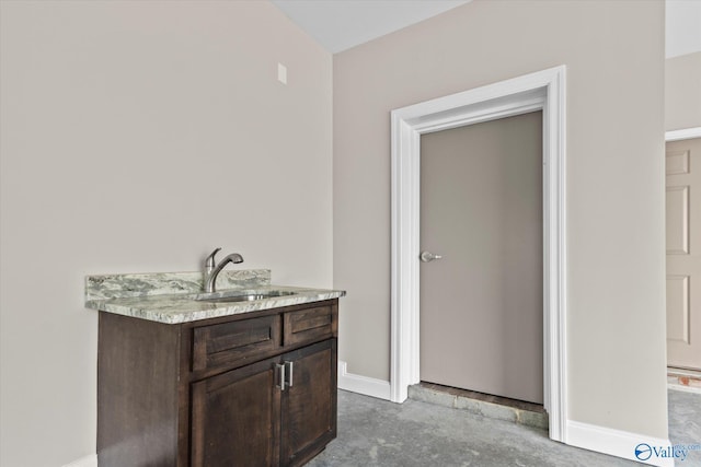 bathroom with vanity and concrete flooring