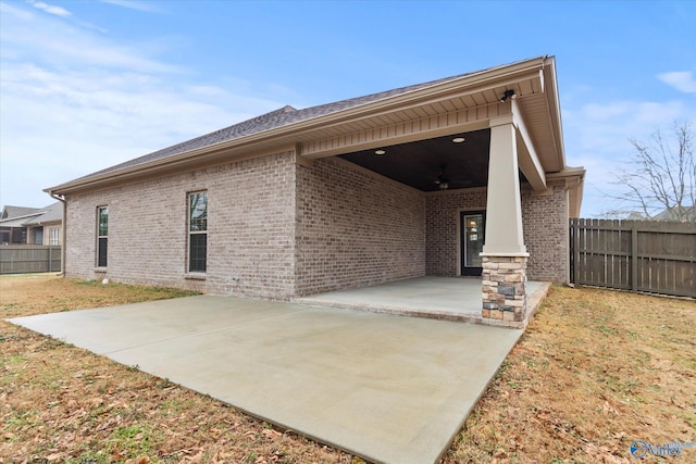 rear view of property with a patio and ceiling fan