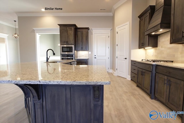 BELLEWOOD-B Mallard Dr, Madison, AL 35756 - kitchen with custom range hood, stainless steel appliances, light wood-style floors, backsplash, and light stone counters