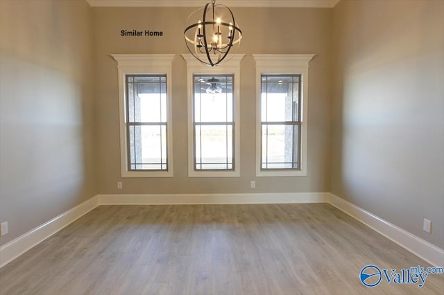 BELLEWOOD-B Mallard Dr, Madison, AL 35756 - spare room with a chandelier, healthy amount of natural light, ornamental molding, and wood finished floors
