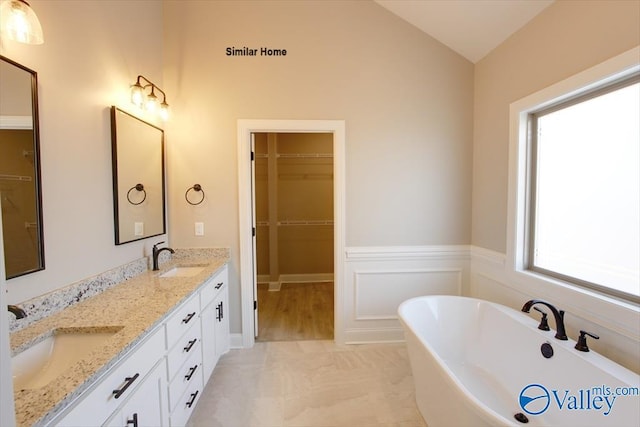 BELLEWOOD-B Mallard Dr, Madison, AL 35756 - bathroom featuring double vanity, a freestanding bath, a spacious closet, and lofted ceiling