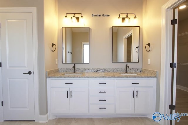 BELLEWOOD-B Mallard Dr, Madison, AL 35756 - bathroom featuring double vanity and baseboards