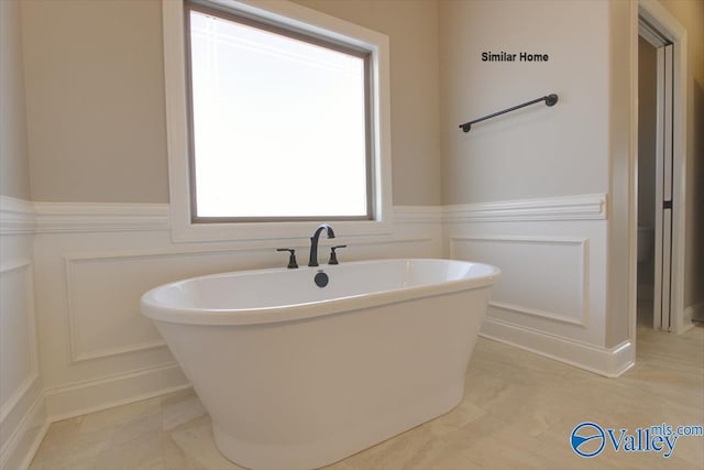 BELLEWOOD-B Mallard Dr, Madison, AL 35756 - full bathroom featuring a decorative wall, a soaking tub, and a wainscoted wall