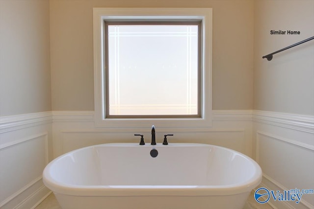 BELLEWOOD-B Mallard Dr, Madison, AL 35756 - full bath with a freestanding tub, wainscoting, and a decorative wall