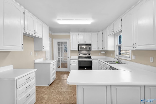 kitchen with stainless steel appliances, kitchen peninsula, and white cabinets