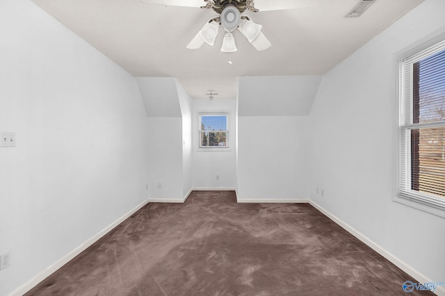 bonus room featuring vaulted ceiling, ceiling fan, and dark carpet