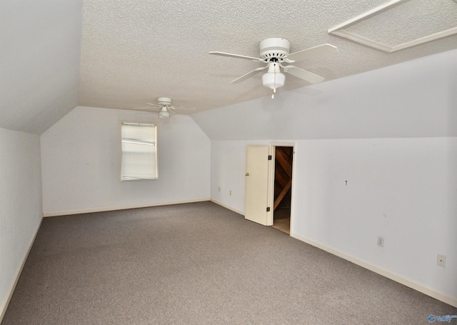 bonus room featuring vaulted ceiling, carpet, ceiling fan, and a textured ceiling