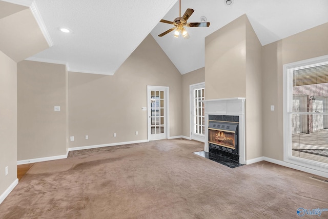 unfurnished living room with high vaulted ceiling, ceiling fan, and carpet flooring