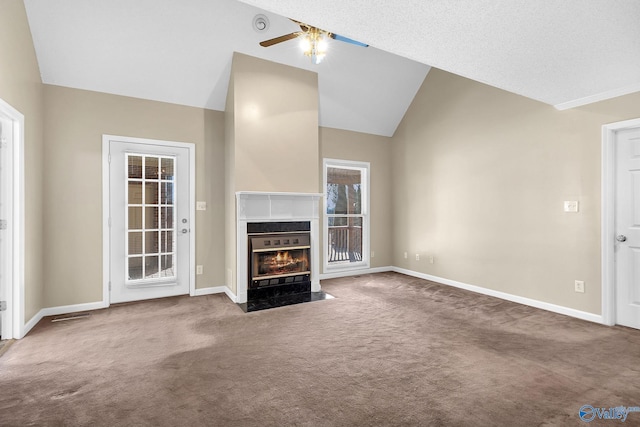 unfurnished living room featuring vaulted ceiling, ceiling fan, and carpet