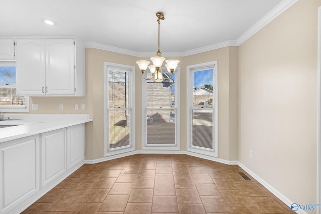 unfurnished dining area with crown molding, light tile patterned floors, and a chandelier