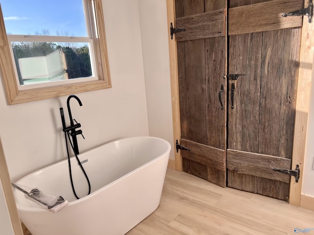 bathroom featuring a bathing tub and hardwood / wood-style floors