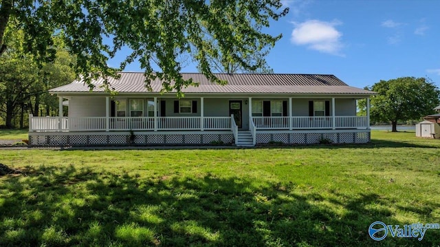 view of front of house with an outdoor structure, a front lawn, a shed, a porch, and metal roof