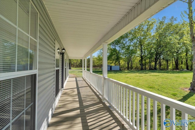 wooden terrace featuring a yard