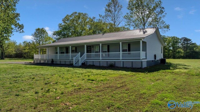 view of front facade featuring central air condition unit, crawl space, a front yard, a porch, and metal roof