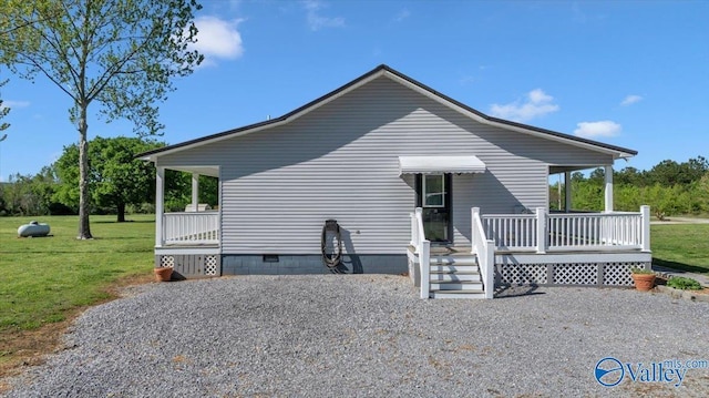back of house featuring a yard, crawl space, and covered porch