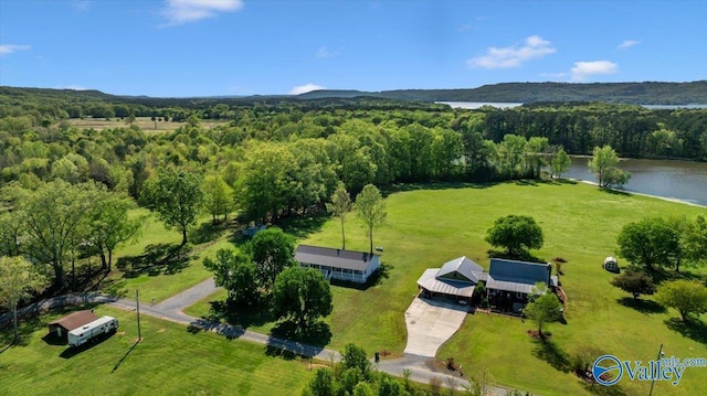 drone / aerial view featuring a water view and a wooded view