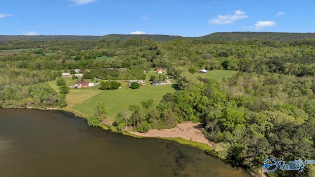 aerial view with a wooded view and a water view
