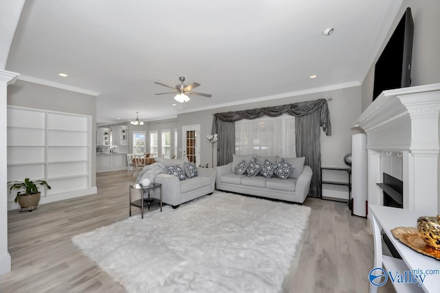 living room with crown molding and light hardwood / wood-style flooring