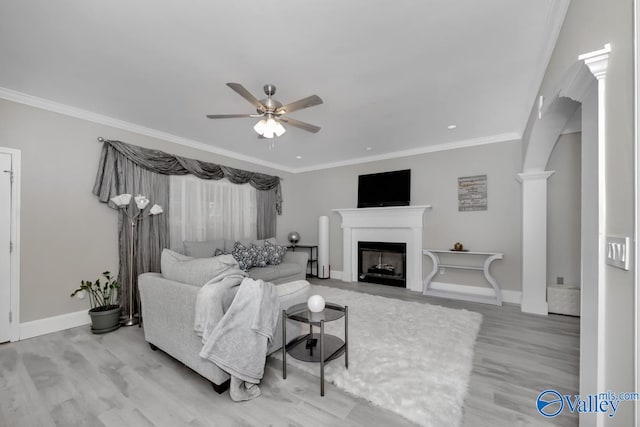 living room with ornate columns, ceiling fan, light hardwood / wood-style floors, and ornamental molding