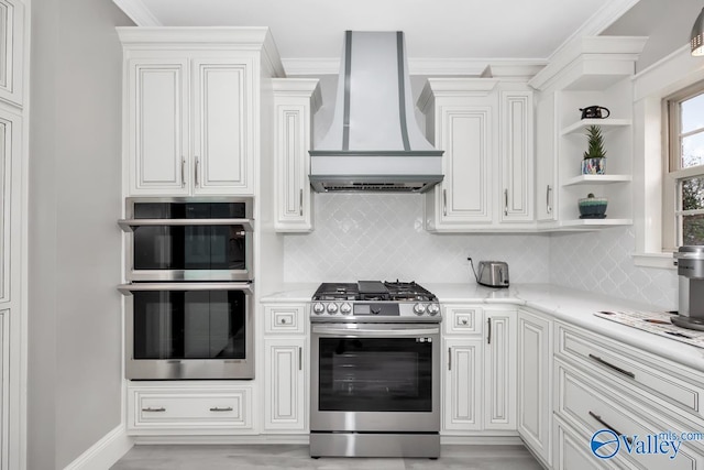 kitchen with light wood-type flooring, backsplash, ornamental molding, custom range hood, and stainless steel appliances