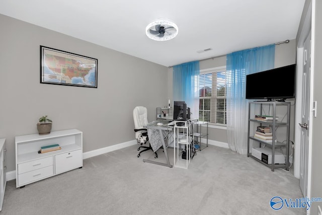 home office featuring ceiling fan and light colored carpet