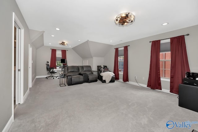 carpeted living room featuring lofted ceiling