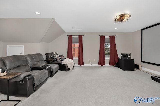 home theater room featuring light carpet and lofted ceiling