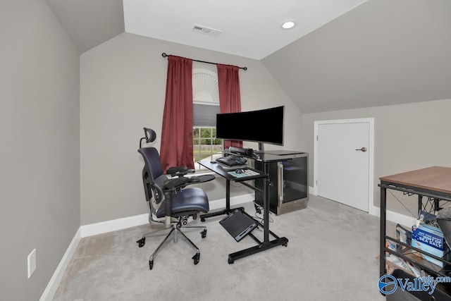 carpeted office featuring vaulted ceiling