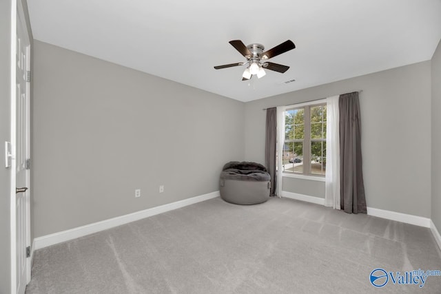 unfurnished room featuring light carpet and ceiling fan