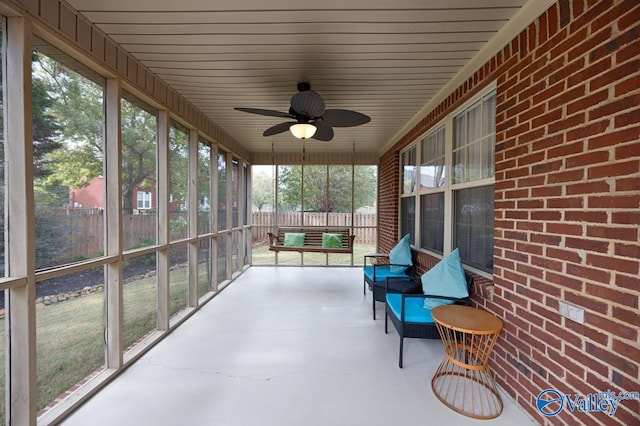 unfurnished sunroom with plenty of natural light and ceiling fan