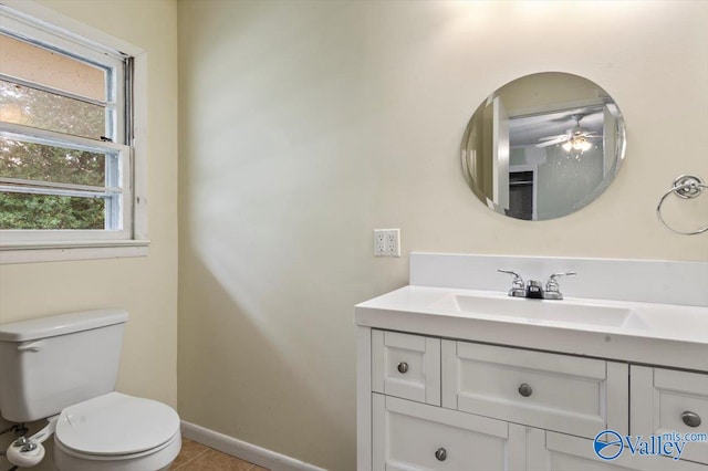 bathroom with toilet, vanity, tile patterned floors, and ceiling fan