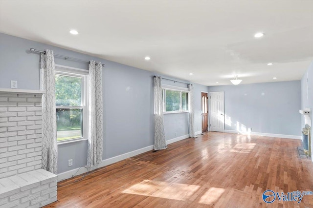 unfurnished living room with wood-type flooring