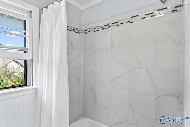 bathroom with shower / bath combo with shower curtain and a healthy amount of sunlight