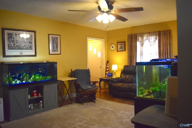 living area featuring a ceiling fan