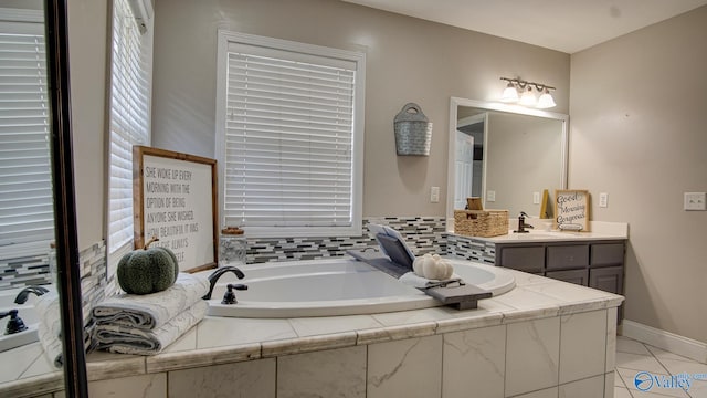 bathroom with vanity, tiled bath, and tile patterned floors