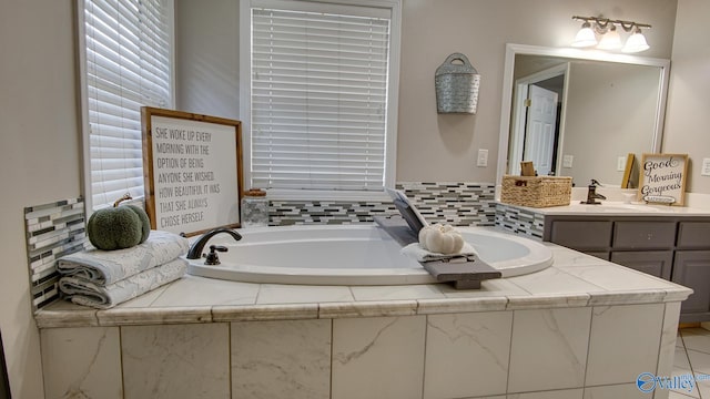 bathroom featuring vanity and a bath