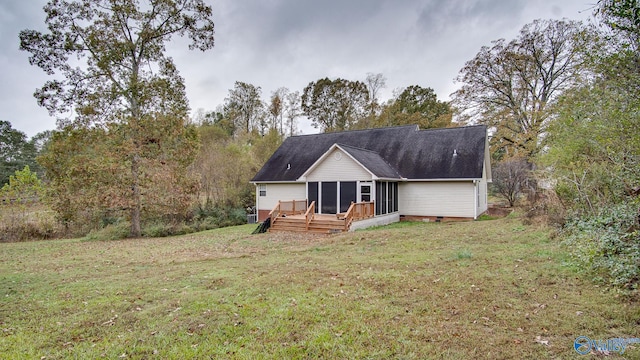 view of front of home featuring a front lawn and a wooden deck