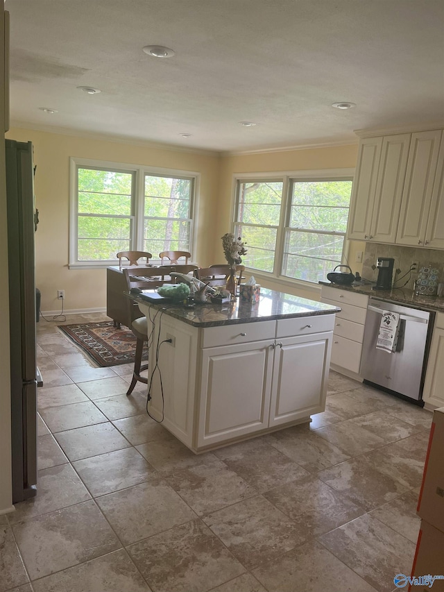6818 Criner Rd SE, Huntsville, AL 35802 - kitchen featuring appliances with stainless steel finishes, plenty of natural light, a center island, dark stone counters, and recessed lighting