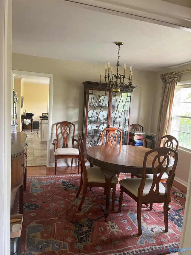6818 Criner Rd SE, Huntsville, AL 35802 - dining area featuring a chandelier, wood finished floors, and baseboards