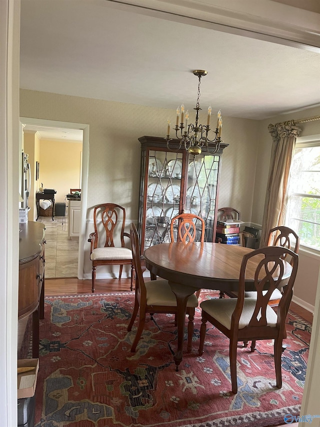 6818 Criner Rd SE, Huntsville, AL 35802 - dining area featuring a chandelier, wood finished floors, and baseboards