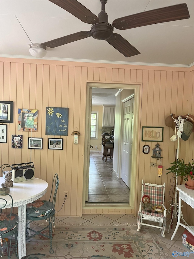 6818 Criner Rd SE, Huntsville, AL 35802 - dining area with tile patterned flooring, ornamental molding, a ceiling fan, and wood walls