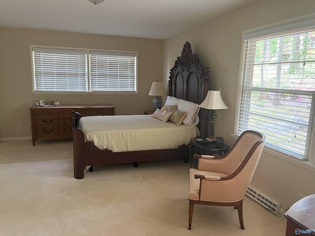 6818 Criner Rd SE, Huntsville, AL 35802 - bedroom featuring multiple windows, light colored carpet, a baseboard heating unit, and baseboards