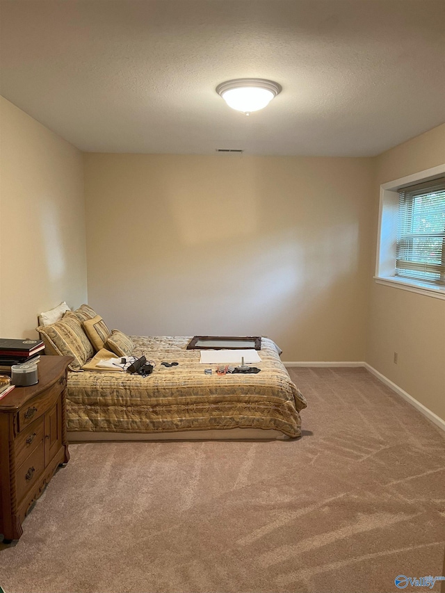 6818 Criner Rd SE, Huntsville, AL 35802 - carpeted bedroom featuring baseboards and a textured ceiling