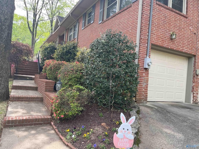 6818 Criner Rd SE, Huntsville, AL 35802 - view of home's exterior with a garage, brick siding, and stairway